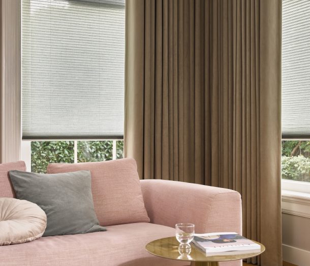 Duettes transparant lichtgroen en gordijnen grijsbeige in woonkamer merk Luxaflex